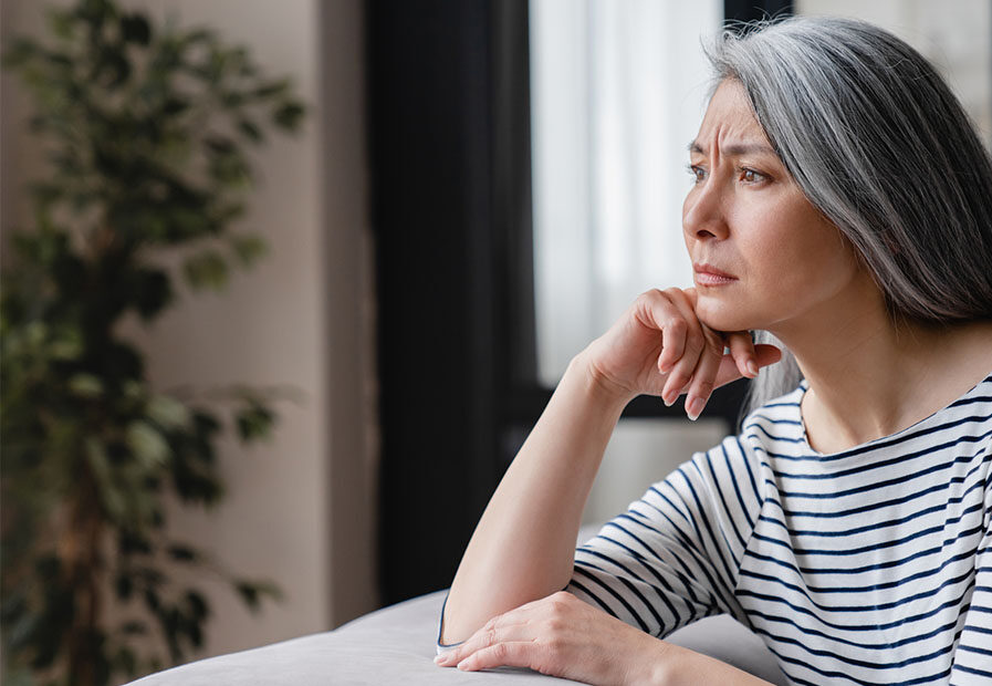 Woman with cognitive decline staring out a window