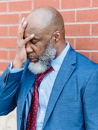 man with cognitive decine holding his head